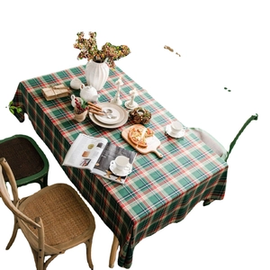 Festive red and green plaid tablecloth made of cotton linen blend on white background