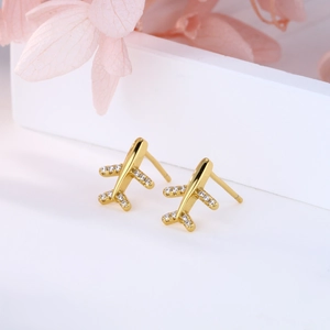 Detail of gold-plated airplane stud earrings with micro-pave white zircon stones