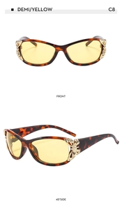 Detail view of wrap-around butterfly sunglasses with tortoiseshell frames and yellow lenses