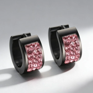 Close-up of black stainless steel U-shaped earrings with rows of pink rhinestones