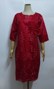 Detailed view of red lace embroidery and A-line hem on the midi dress with five-point sleeves