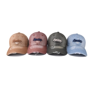 Washed denim baseball cap with distressed holes and London ONLY embroidery in four colors