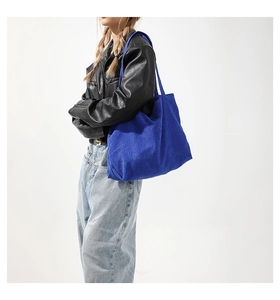 Close-up of blue corduroy tote bag showing ribbed texture and large capacity size