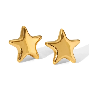 Detail shot of high-polished 18K gold star stud earrings with glossy metallic finish