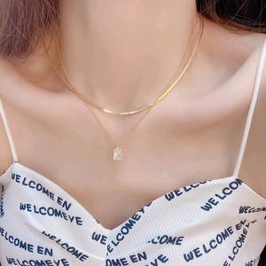 Double-layered gold titanium necklace with square zircon pendant worn by model