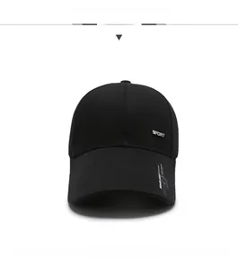Detail of black cotton baseball cap showing metal Sport tag and printed brim text