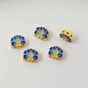 Detailed view of 18K gold flower beads with blue enamel and zircon inlay for DIY jewelry