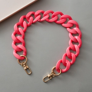 Macro shot of bright pink resin chain link strap with gold metal lobster clasp