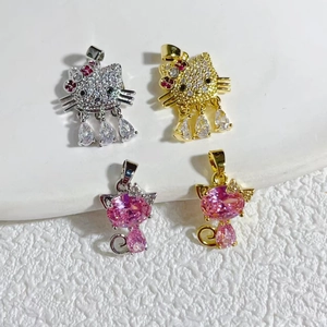 Detailed view of 18K gold plated cat pendants with pink and white zirconia stones