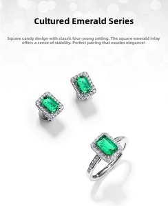 Macro detail of emerald-cut lab emerald jewelry set with vintage silver setting