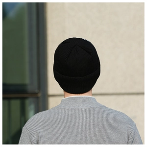 Rear view of a black ribbed knit beanie showing high-quality texture and thermal thick fabric