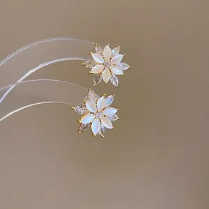 Exquisite gold floral stud earrings with white cat-eye stones and cubic zirconia