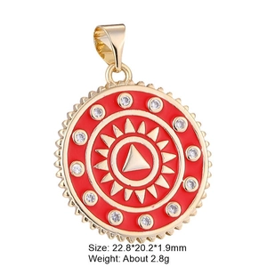 Gold plated copper heart pendant with red enamel and zircon inlay on white background