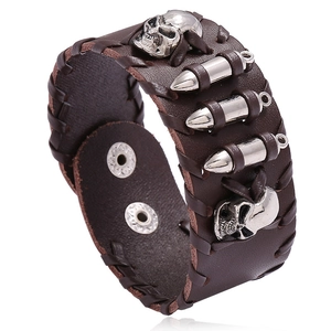 Punk brown leather motorcycle bracelet with metal skull and bullet charms on white background