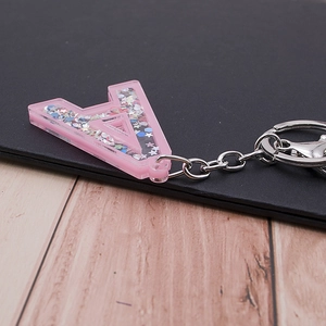 Pink acrylic letter A keychain with colorful star sequins and silver metal ring