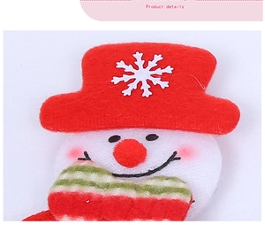Detail of plush Christmas snowman ornament with red hat and striped scarf decoration