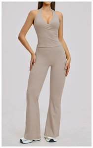 Detail of high-waist flared yoga pants and halter neck sports top in khaki stretch fabric