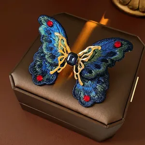 Vintage butterfly open ring with blue embroidery and crystals on a premium jewelry box