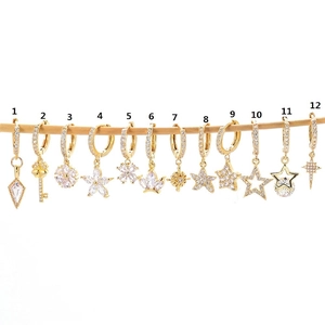Collection of twelve gold starfish and geometric huggie earrings with sparkling zircons