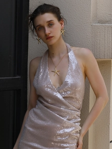 Close-up of model wearing 18K gold plated starfish earrings and necklace set