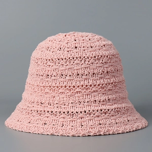 Close-up of pink knitted bucket hat showing breathable hollow mesh and texture