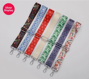 Close-up of assorted patterned replacement bag straps with silver metal swivel hooks
