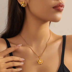 Gold-plated floral jewelry set with pearls featuring a minimalist necklace and stud earrings