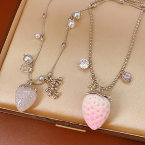 Detail of strawberry pearl necklace featuring flocked pendants and sparkling pink gemstones