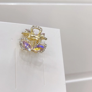 Mini rabbit ear hair claw clip with purple rhinestones and golden metal finish