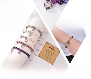 Detail of adjustable natural stone bead bracelet with heart charm and teacher gift card