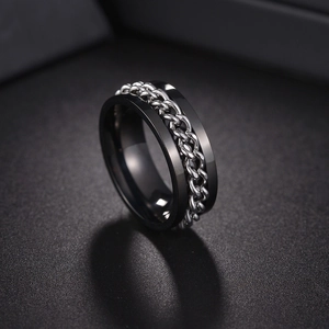 Detail shot of black titanium spinner ring with silver cuban chain inlay for men