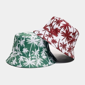 Reversible bucket hats with palm tree prints in dark green and white summer design