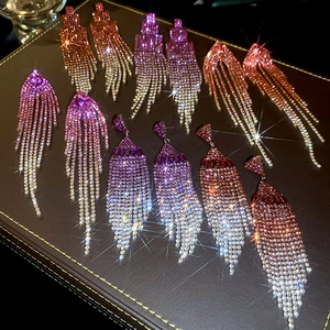 Detailed close-up of sparkling rhinestone tassel earrings with a vibrant gradient color finish