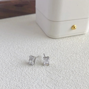 Close-up of S925 sterling silver stud earrings with rectangle-cut white zircon settings