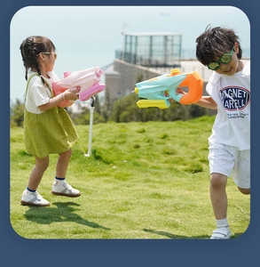 Action shot of kids playing with 1200ml large capacity water guns on a sunny outdoor lawn