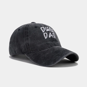 Detail of gray washed cotton baseball cap with white DOG DAD embroidery and paw icon