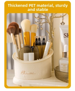 Detail of creamy white cosmetic brush holder with water drop texture and gold lettering