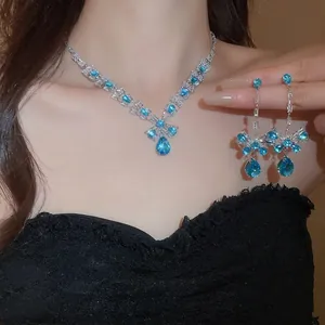 Luxury blue teardrop zircon necklace and earrings set worn by model in black lace