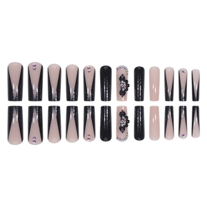 Long coffin fake nails with black French tips, glitter flowers, and sparkling crystals