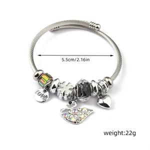 Detail view of steel charm bracelet showing love heart and clover charms with dimensions
