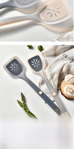 Close-up of heat-resistant silicone spatula with hollow petal design and non-slip handle