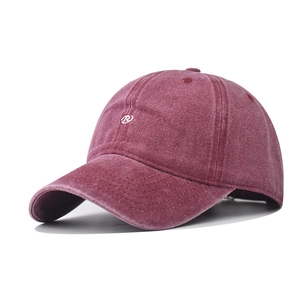 Detail view of burgundy washed cotton baseball cap with white embroidered R logo