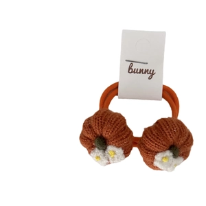 Pair of cute knitted pumpkin hair ties for children with white floral decorations