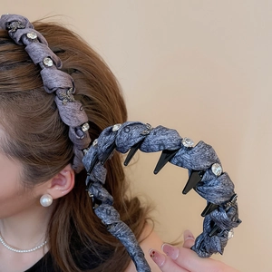 Detail of dark grey fabric headband with sparkling rhinestones and anti-slip teeth