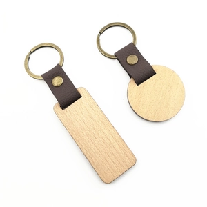 Rectangle and round walnut wood keychains with brown leather straps and bronze rings