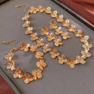 Detailed view of golden flower jewelry set including necklace, bracelet and earrings