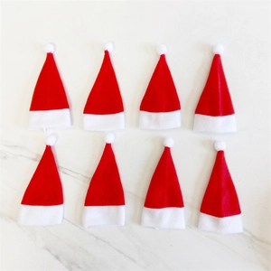 Set of 8 mini red and white Christmas lollipop hats on white marble surface