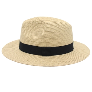 Close-up of woven straw texture and elegant black ribbon detail on a Panama hat