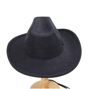 Detailed view of black wool felt cowboy hat with wide brim and woven decorative band