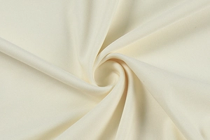 Detailed macro shot of premium cream-colored lace fabric with fine woven texture and soft drape